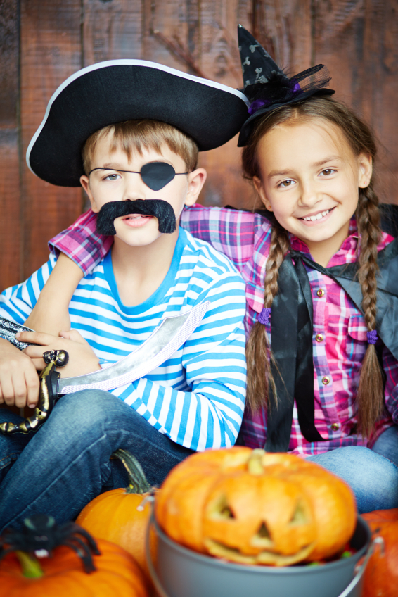 little children in Halloween costumes of pirate and witch