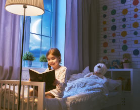 girl reading book at bedtime