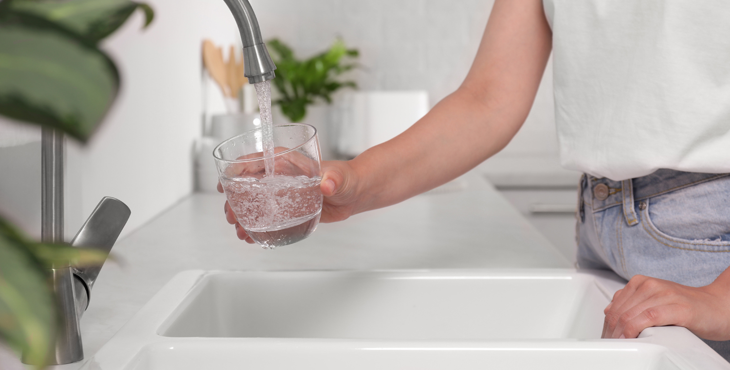 filling water glass at sink