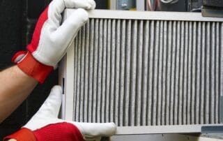 Burton technician replacing air filter during HVAC Maintenance Service