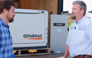 employees showing a whole home generator